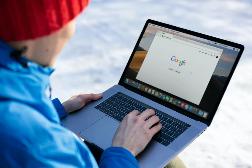 Person using laptop in snowy environment